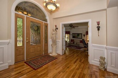 Large foyer is flanked by study and dining room