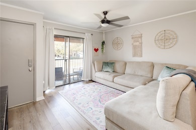 Living area with ceiling fan, wood finished floors