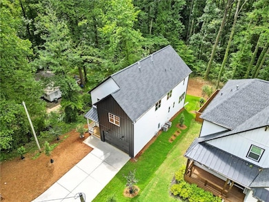 View from above of property featuring a heavily wooded area