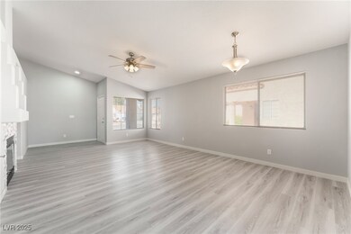Unfurnished living room with ceiling fan, vaulted