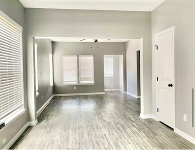 Spare room with plenty of natural light, light wood-type flooring, and a ceiling fan
