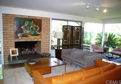 LIVING ROOM WITH NEUTRAL BRICK FIREPLACE WITH RAIS