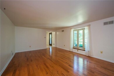 The formal living room has a bay window overlookin