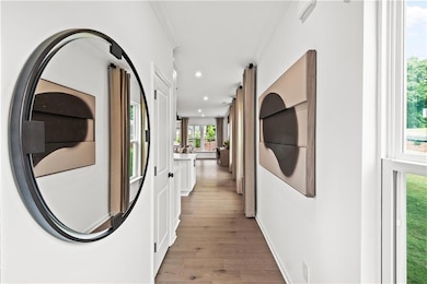 Hallway featuring recessed lighting and wood finished floors