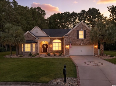 View of front of house featuring a front lawn, concrete driveway, and a garage