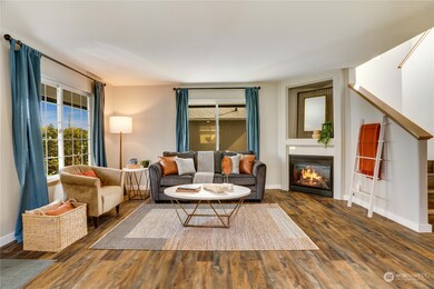The main floor's open layout begins with a fireside living room warmed by a gas insert fireplace and brightened by big windows facing east and north.