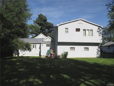 Spacious backyard is partially fenced.
