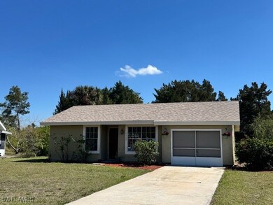 Ranch-style house with a garage, a front yard, con