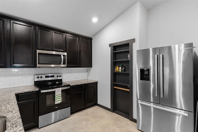 Kitchen featuring appliances with stainless steel