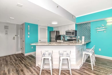 Kitchen with a breakfast bar area, white cabinetry