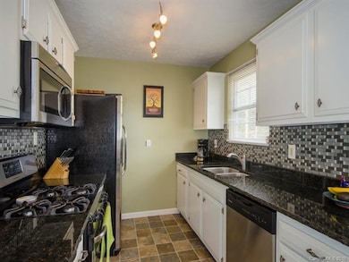 Cook's kitchen comes with stainless appliances, granite countertops, and a beautiful backsplash