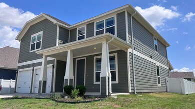 View of front of property with covered porch and a garage