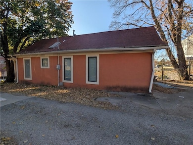 View of front of house featuring stucco siding and roof with shingles