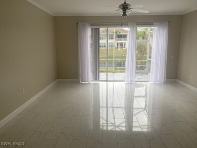 Spare room featuring ceiling fan, crown molding, and light tile patterned flooring