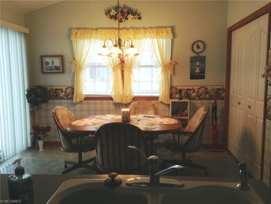 The far end of the kitchen has a large eating area