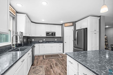 Kitchen featuring a sink, dark wood finished floor