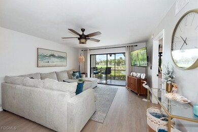 Living room with light wood-style floors and ceiling fan