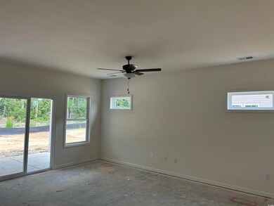 Unfurnished room with baseboards, ceiling fan, and unfinished concrete flooring