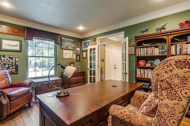 Bright window, intricate trim work, and French doo
