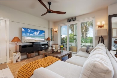 Living room featuring ceiling fan and tile patterned flooring