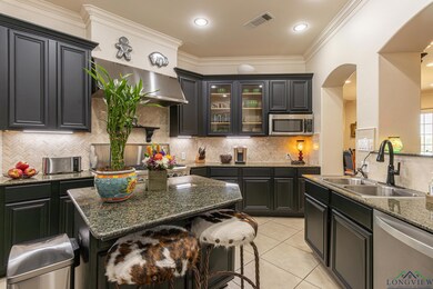 Kitchen featuring sink, crown molding, stainless s