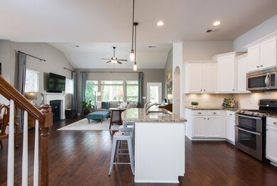 Open floor plan with granite covered counters, lots of light, fireplace and dining room. 