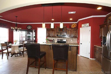 The island kitchen is open to great room with eati