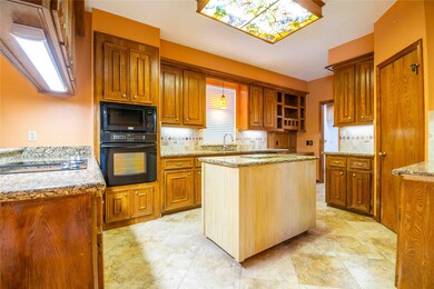 Kitchen has abundant cabinet storage, granite counter tops, plenty of light, and a walk-in pantry.