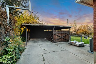 Garage at dusk featuring a gate