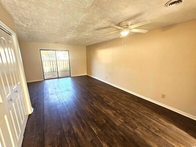 Empty room with a textured ceiling, ceiling fan, a