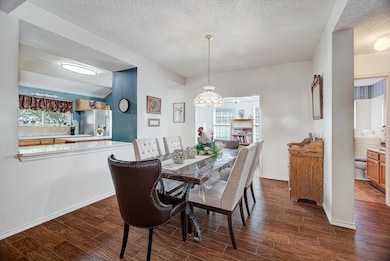 Dining Area – Formal dining space with room for a large table, complemented by wood flooring and natural light from nearby windows.