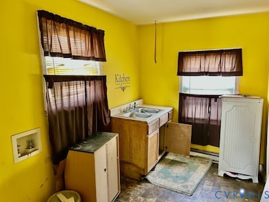 Laundry area featuring plenty of natural light, washer hookup, and baseboard heating