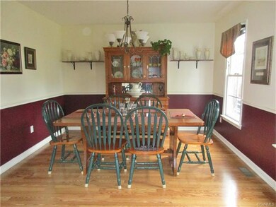 Dining room offers laminate floors with chair rail.