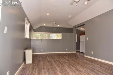 Unfurnished room with a ceiling fan, lofted ceiling, wood finished floors, baseboards, and recessed lighting