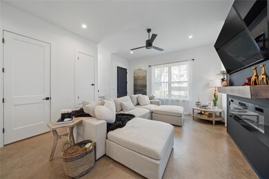 Living room with concrete flooring, recessed ligh
