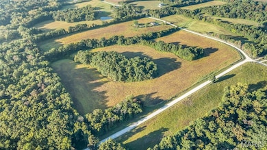Aerial view of property's location with a forest