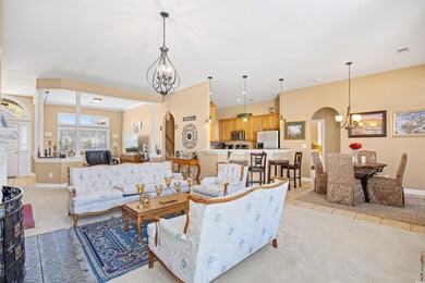 Living room with light colored carpet, arched walk