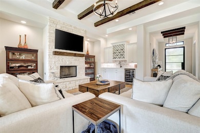 Living room with beverage cooler, a chandelier, b