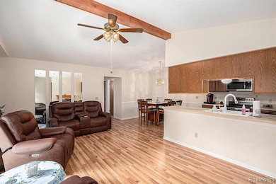 Living area featuring light wood finished floors and ceiling fan