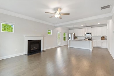 Unfurnished living room with ceiling fan, a health