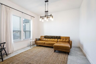 Sitting room with a notable chandelier and a wealt