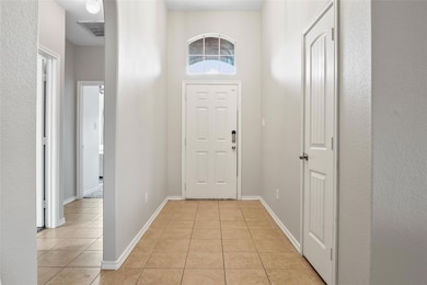 Entryway featuring light tile patterned floors, ba