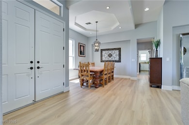 Foyer featuring light wood-type flooring, baseboar