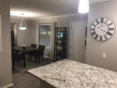 Dining room featuring ornamental molding, dark har