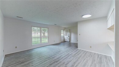Empty room featuring light parquet floors and a te
