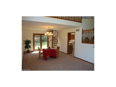 Dining Area with Winding Staircase to upstairs