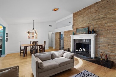 Living room with a chandelier, vaulted ceiling, l
