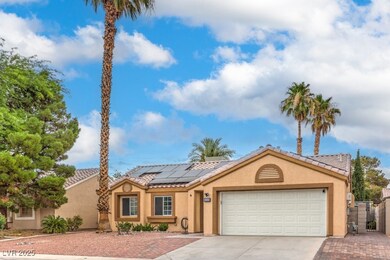 View of front facade with driveway, stucco siding,