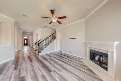 Unfurnished living room with ornamental molding, a