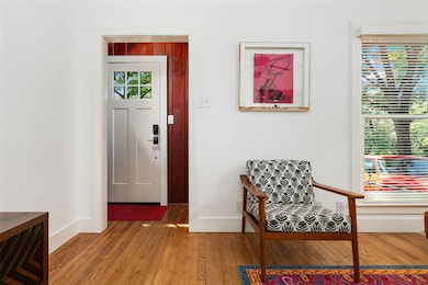 Foyer entrance with wood finished floors and base